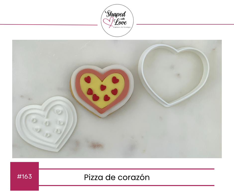 Heart-shaped cookie with colorful design and matching cookie cutter on a marble surface, branded 'Shaped for Love'.